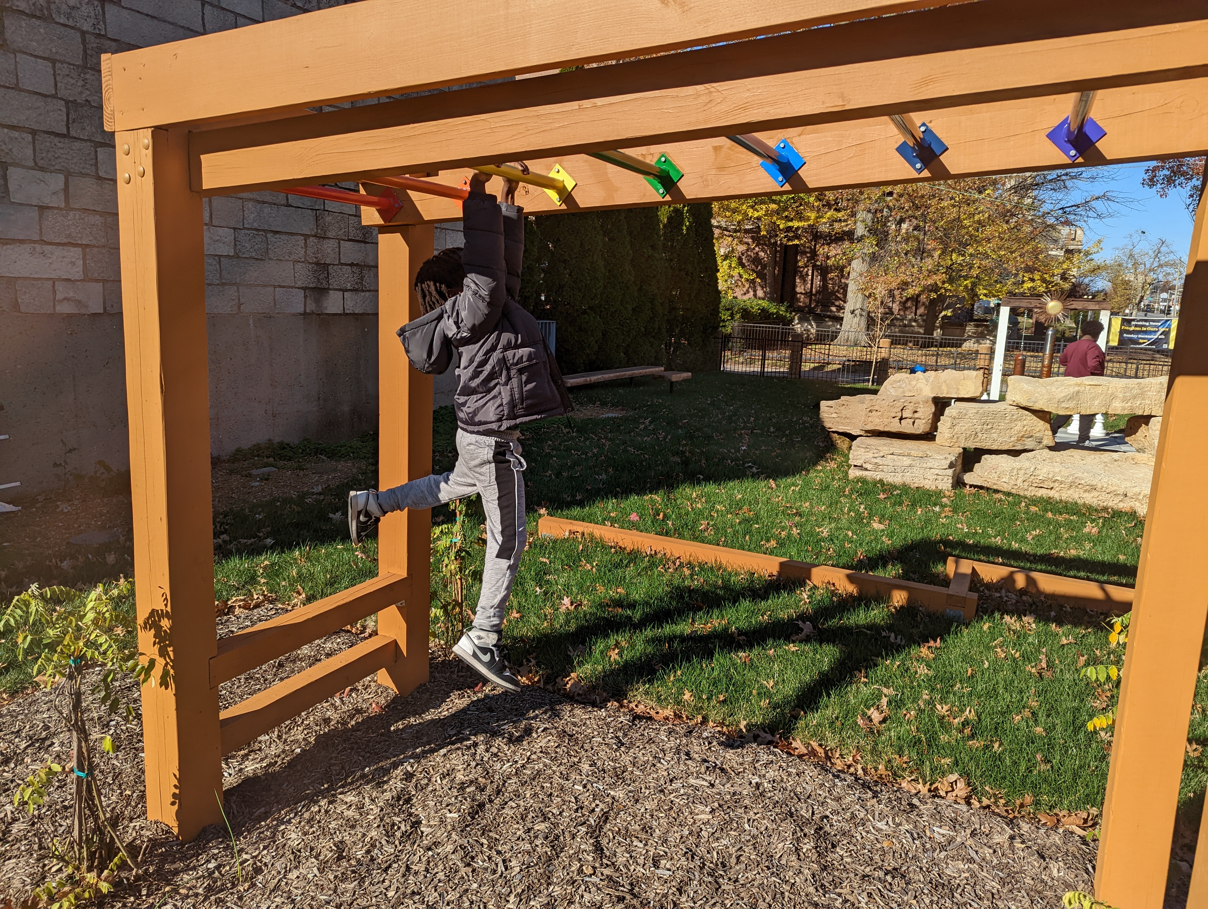 A kid playing on the monkey bars
